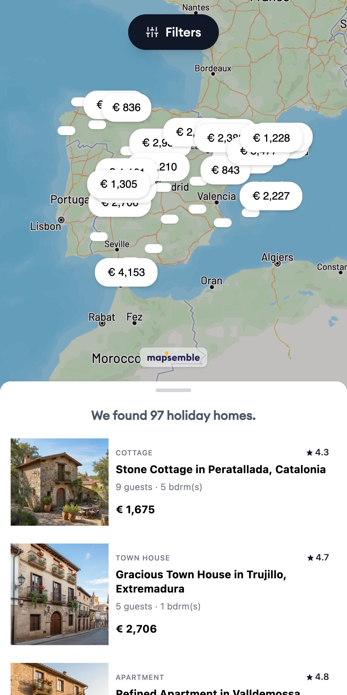 The same holiday-homes demo map on mobile: map with price markers above a swipeable list of results